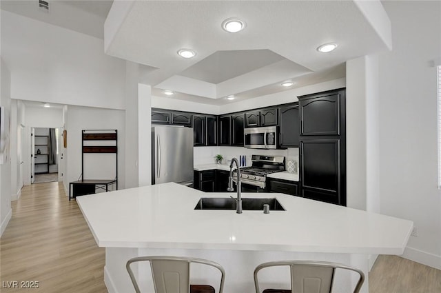 201 Crown Imperial St, Henderson, NV 89074 - kitchen with stainless steel appliances, light wood-style floors, light countertops, dark cabinets, and recessed lighting