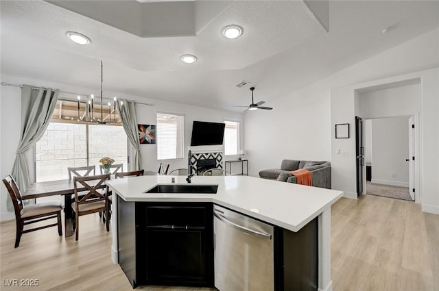 201 Crown Imperial St, Henderson, NV 89074 - kitchen with dishwasher, light countertops, a chandelier, light wood-style flooring, and vaulted ceiling