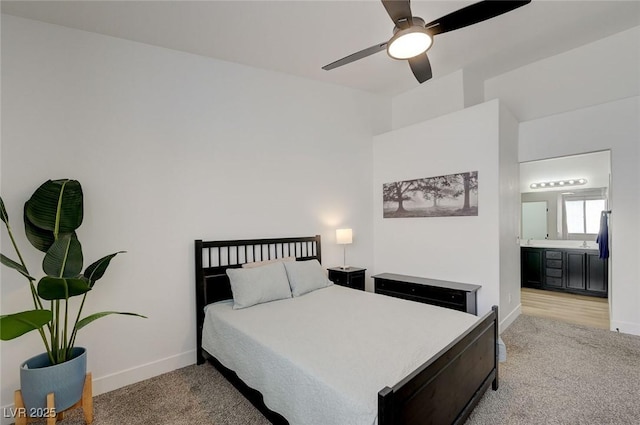201 Crown Imperial St, Henderson, NV 89074 - bedroom featuring light colored carpet, connected bathroom, and a ceiling fan