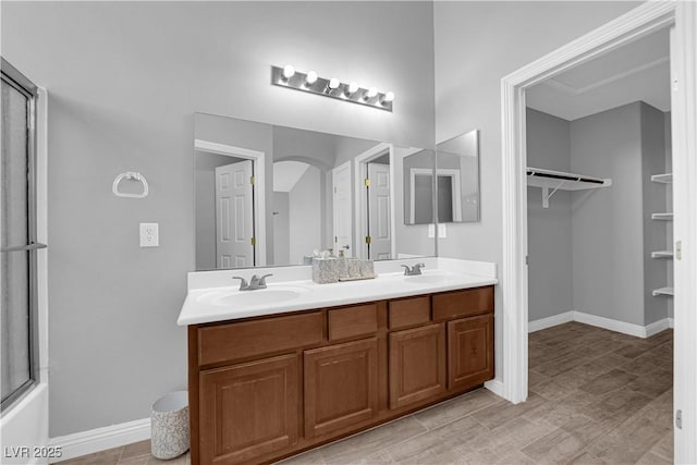 8658 Tom Noon Ave Unit 103, Las Vegas, NV 89178 - bathroom with double vanity, a spacious closet, and a shower with door