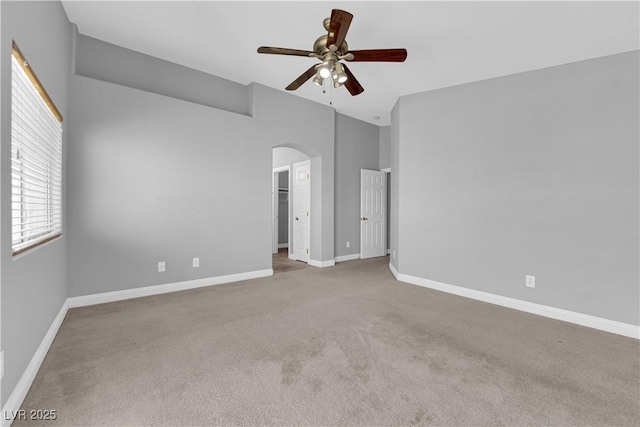 8658 Tom Noon Ave Unit 103, Las Vegas, NV 89178 - unfurnished bedroom with carpet flooring, arched walkways, vaulted ceiling, a walk in closet, and ceiling fan