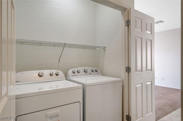 2508 Chasma Dr, Henderson, NV 89044 - laundry area featuring washing machine and clothes dryer, light carpet, and light tile patterned flooring