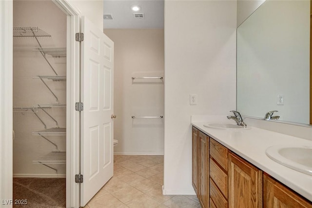 2508 Chasma Dr, Henderson, NV 89044 - bathroom with double vanity, tile patterned flooring, and a spacious closet