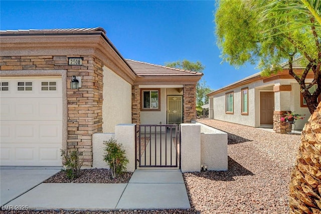 2508 Chasma Dr, Henderson, NV 89044 - entrance to property with a gate, stucco siding, a garage, a tiled roof, and stone siding