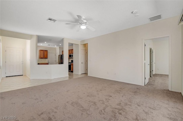 2508 Chasma Dr, Henderson, NV 89044 - unfurnished living room with light colored carpet, a ceiling fan, recessed lighting, and light tile patterned floors