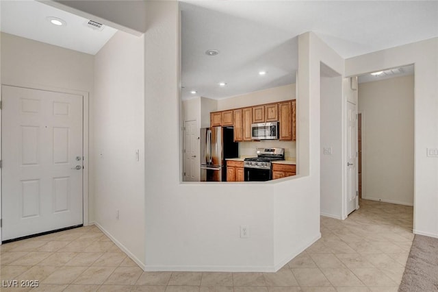 2508 Chasma Dr, Henderson, NV 89044 - kitchen featuring appliances with stainless steel finishes, light tile patterned floors, brown cabinets, recessed lighting, and light countertops