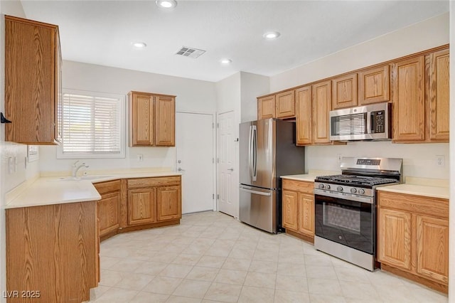 2508 Chasma Dr, Henderson, NV 89044 - kitchen with appliances with stainless steel finishes, light countertops, recessed lighting, and brown cabinets