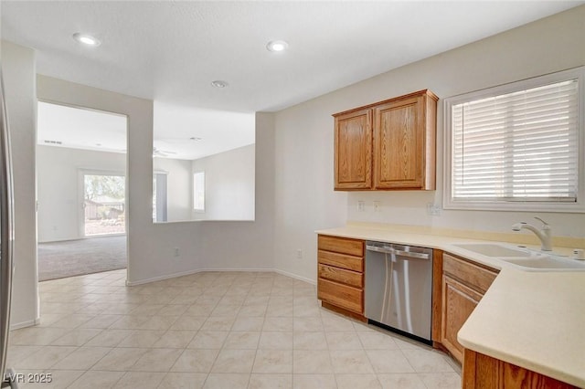 2508 Chasma Dr, Henderson, NV 89044 - kitchen with stainless steel dishwasher, light countertops, brown cabinetry, recessed lighting, and light tile patterned floors