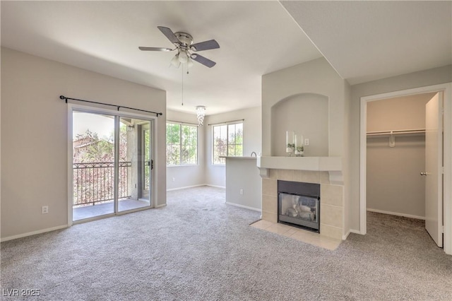 9050 W Warm Springs Rd Unit 2062, Las Vegas, NV 89148 - unfurnished living room featuring carpet, a ceiling fan, and a tiled fireplace