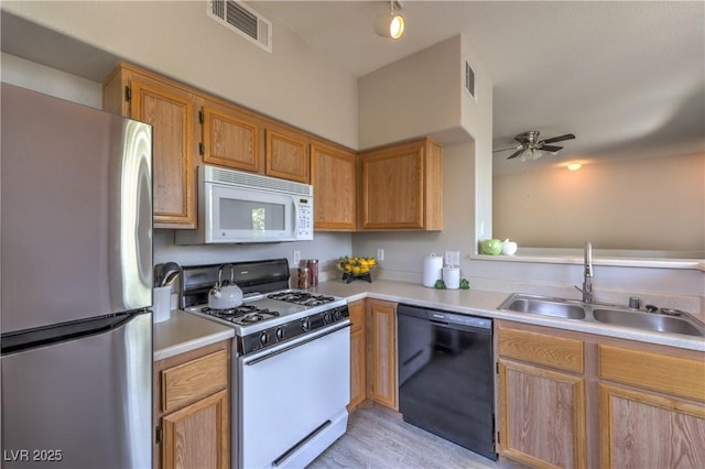 9050 W Warm Springs Rd Unit 2062, Las Vegas, NV 89148 - kitchen with white appliances, light countertops, ceiling fan, and light wood finished floors