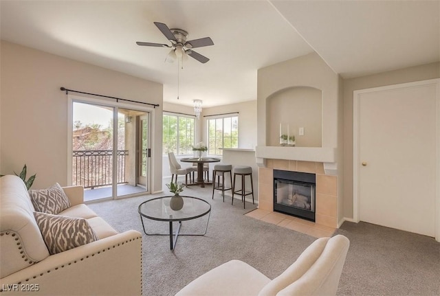 9050 W Warm Springs Rd Unit 2062, Las Vegas, NV 89148 - carpeted living room featuring a ceiling fan and a fireplace