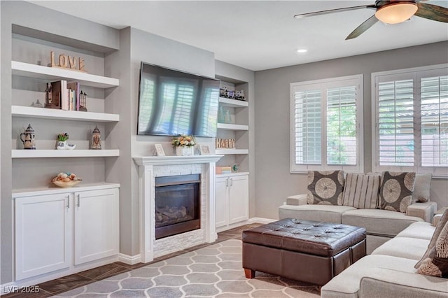 2433 Amatrice St, Henderson, NV 89044 - living area featuring built in features, a glass covered fireplace, healthy amount of natural light, ceiling fan, and recessed lighting
