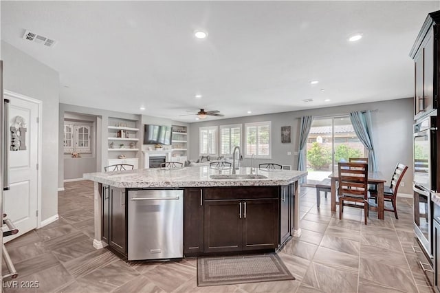 2433 Amatrice St, Henderson, NV 89044 - kitchen featuring a ceiling fan, dark brown cabinetry, an island with sink, stainless steel appliances, and recessed lighting