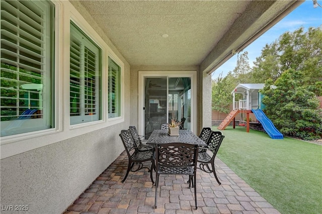 2433 Amatrice St, Henderson, NV 89044 - view of patio / terrace featuring outdoor dining area and a playground