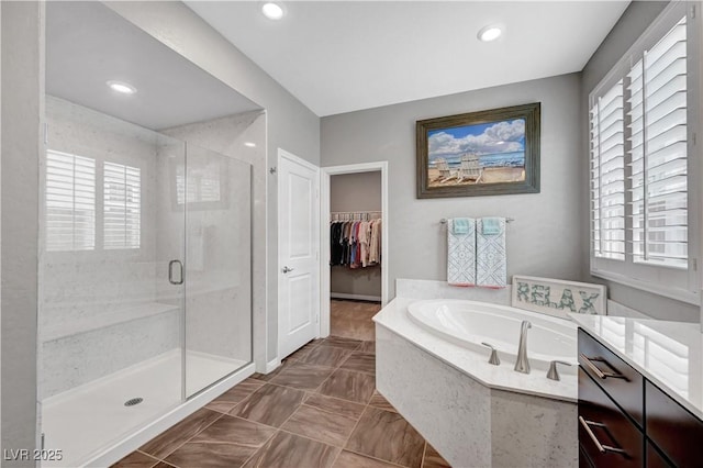 2433 Amatrice St, Henderson, NV 89044 - bathroom with a garden tub, a stall shower, plenty of natural light, and recessed lighting