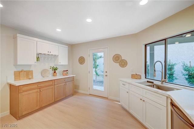 1905 Plaza Del Padre, Las Vegas, NV 89102 - kitchen with dishwasher, recessed lighting, light wood finished floors, light countertops, and white cabinets