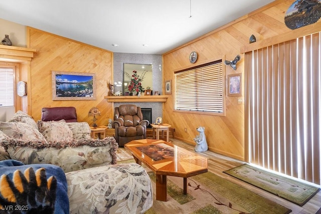 816 Sandsprings St, Henderson, NV 89011 - living area featuring healthy amount of natural light, wooden walls, a fireplace with raised hearth, and wood finished floors