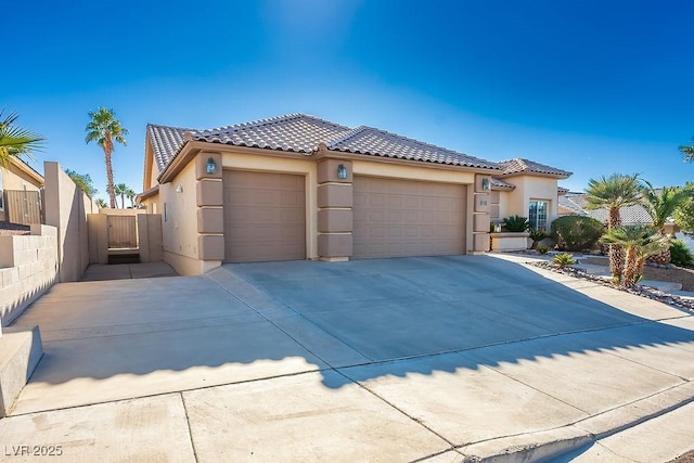 816 Sandsprings St, Henderson, NV 89011 - mediterranean / spanish house with stucco siding, a garage, a tiled roof, concrete driveway, and a gate