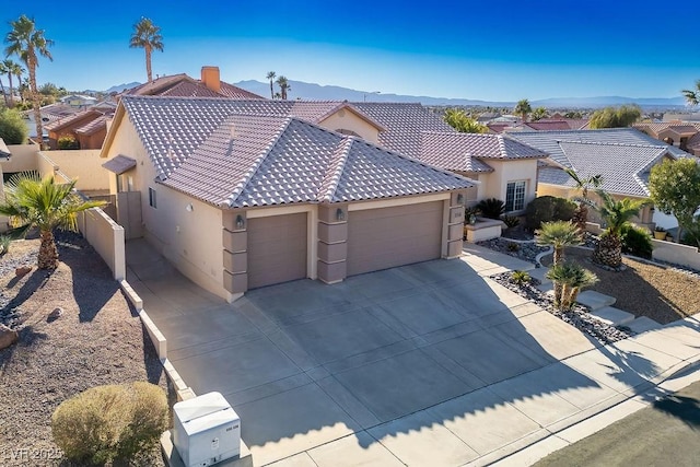 816 Sandsprings St, Henderson, NV 89011 - mediterranean / spanish house with a garage, stucco siding, driveway, and a tiled roof