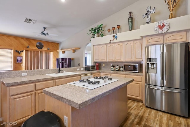 816 Sandsprings St, Henderson, NV 89011 - kitchen with appliances with stainless steel finishes, light brown cabinets, a peninsula, and a center island
