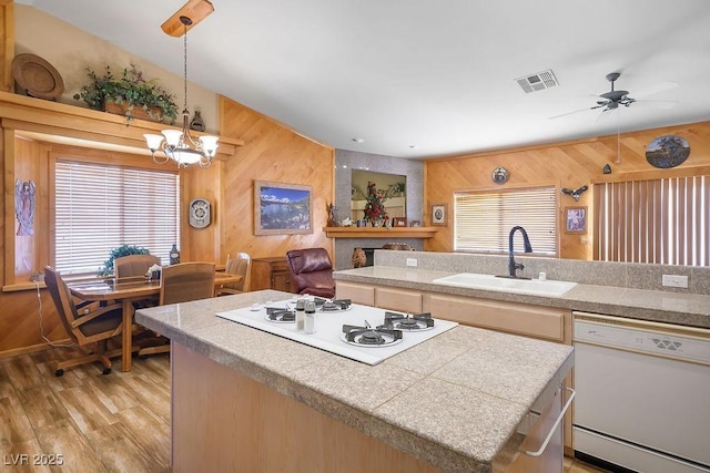 816 Sandsprings St, Henderson, NV 89011 - kitchen with white appliances, wooden walls, tile counters, a center island, and healthy amount of natural light
