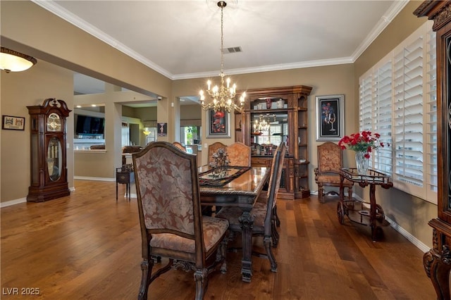 1704 River Birch St, Las Vegas, NV 89117 - dining area with a chandelier, dark wood-style floors, and crown molding