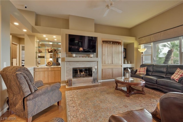 1704 River Birch St, Las Vegas, NV 89117 - living area featuring a premium fireplace, ceiling fan, wood finished floors, and recessed lighting