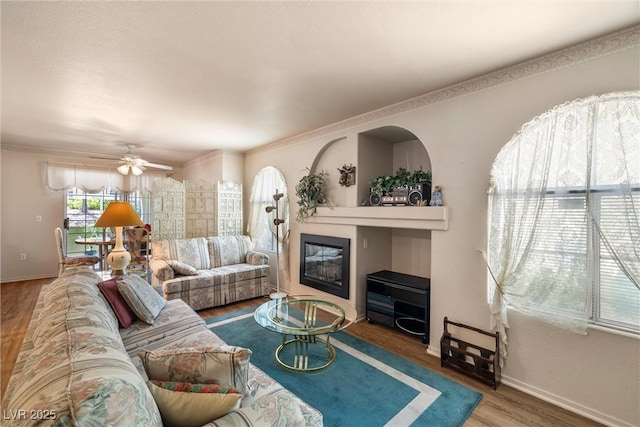 7950 W Flamingo Rd Unit 1024, Las Vegas, NV 89147 - living room featuring wood finished floors, a glass covered fireplace, and ceiling fan