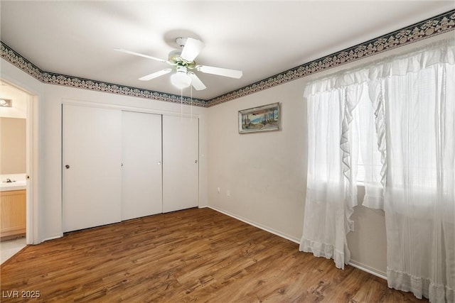 7950 W Flamingo Rd Unit 1024, Las Vegas, NV 89147 - unfurnished bedroom with wood finished floors, a ceiling fan, and a closet