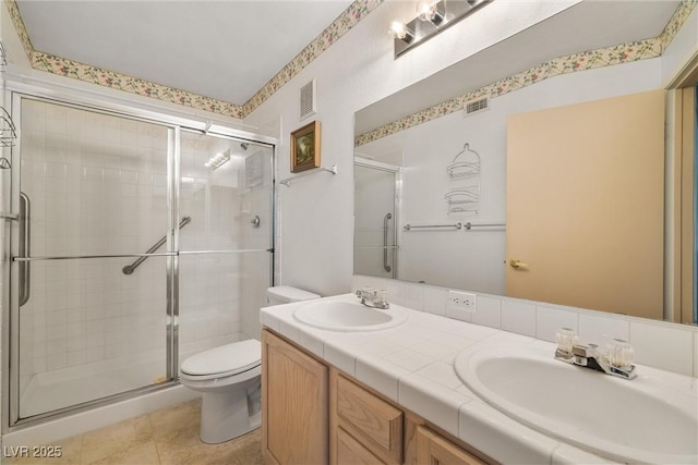 7950 W Flamingo Rd Unit 1024, Las Vegas, NV 89147 - bathroom featuring a stall shower, double vanity, and tile patterned flooring