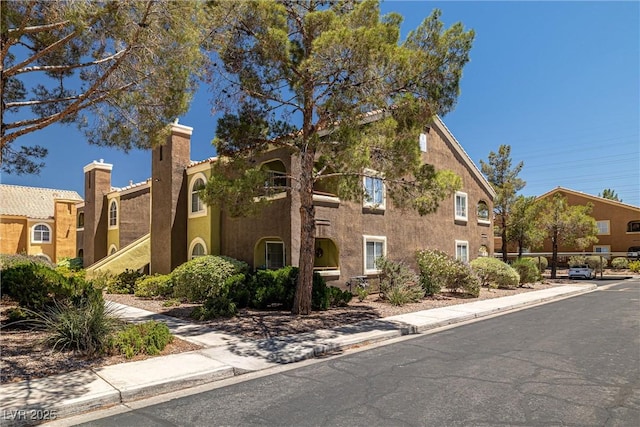 7950 W Flamingo Rd Unit 1024, Las Vegas, NV 89147 - view of front of home with stucco siding and a chimney