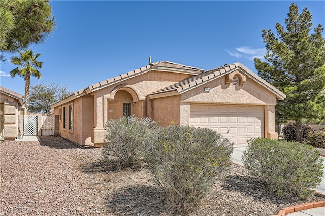 1038 Silver Creek Ave, Las Vegas, NV 89183 - view of front of house with an attached garage and stucco siding