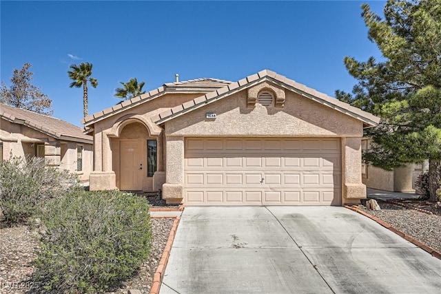 1038 Silver Creek Ave, Las Vegas, NV 89183 - view of front of house with concrete driveway, a garage, stucco siding, and a tile roof