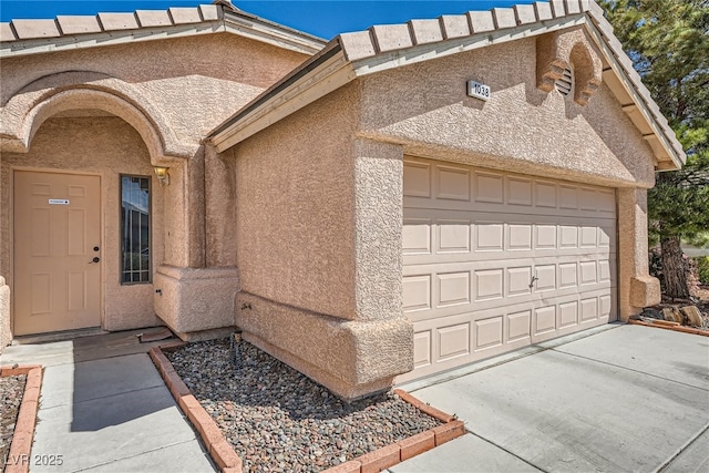 1038 Silver Creek Ave, Las Vegas, NV 89183 - doorway to property featuring stucco siding, concrete driveway, and an attached garage