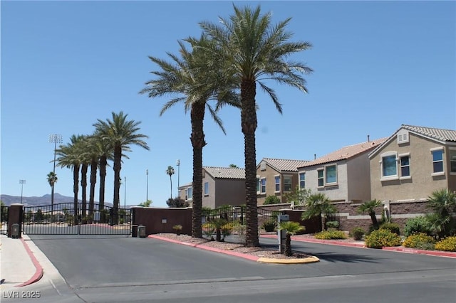 6922 Majestic Palm Dr, Las Vegas, NV 89122 - view of asphalt street featuring a gate, a gated entry, curbs, and a residential view