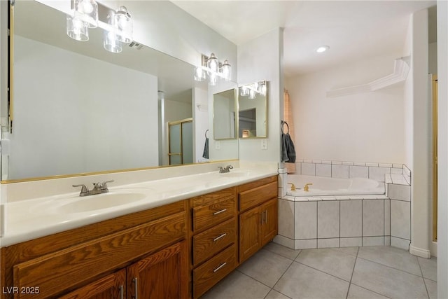 901 E Jaybird St, Pahrump, NV 89048 - bathroom featuring tile patterned floors, a bath, double vanity, a stall shower, and recessed lighting