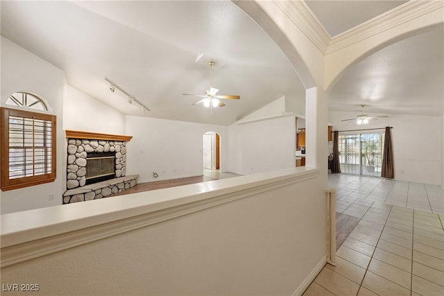 901 E Jaybird St, Pahrump, NV 89048 - kitchen with ceiling fan, open floor plan, vaulted ceiling, tile patterned floors, and a stone fireplace