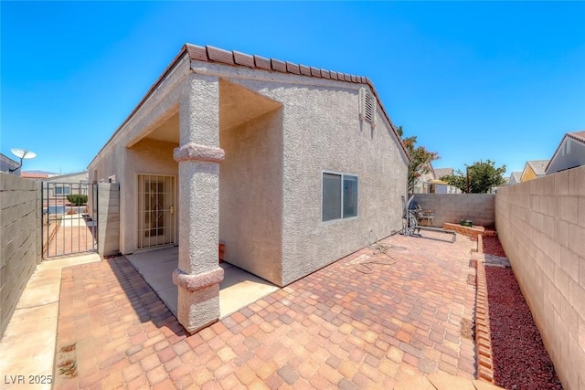 1717 Dwayne Stedman Ave, Las Vegas, NV 89106 - view of side of property with a fenced backyard, stucco siding, a patio area, and a gate