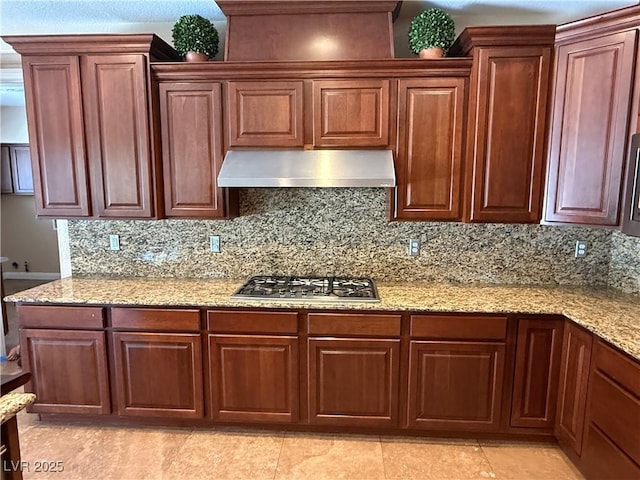585 Via Alhambra, Las Vegas, NV 89123 - kitchen with extractor fan, stainless steel gas cooktop, tasteful backsplash, light stone countertops, and light tile patterned flooring