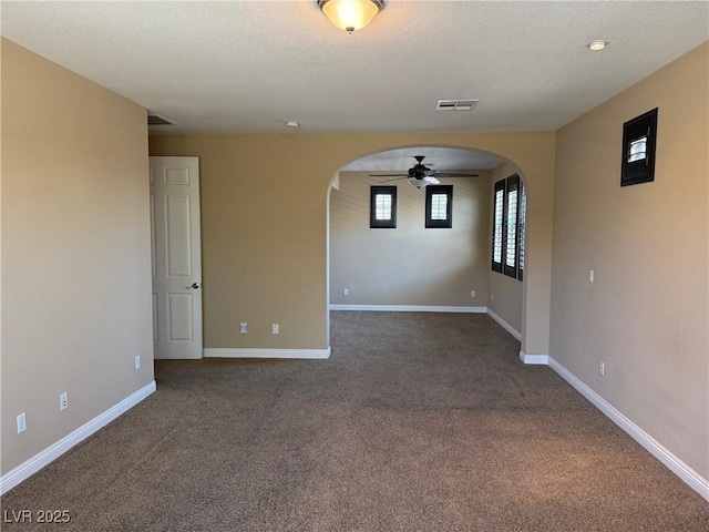 585 Via Alhambra, Las Vegas, NV 89123 - empty room with arched walkways, ceiling fan, and carpet
