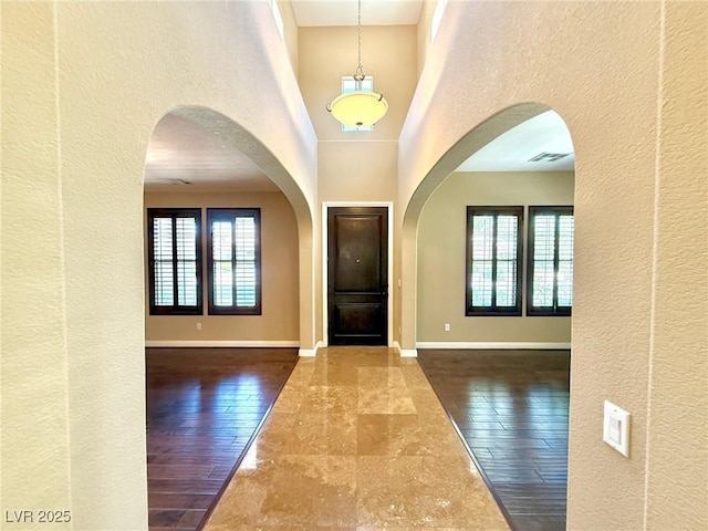 585 Via Alhambra, Las Vegas, NV 89123 - foyer with a textured wall, a high ceiling, hardwood / wood-style floors, and arched walkways