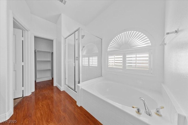 4029 Ricebird Way N, Las Vegas, NV 89084 - bathroom featuring a shower stall, a garden tub, and wood finished floors