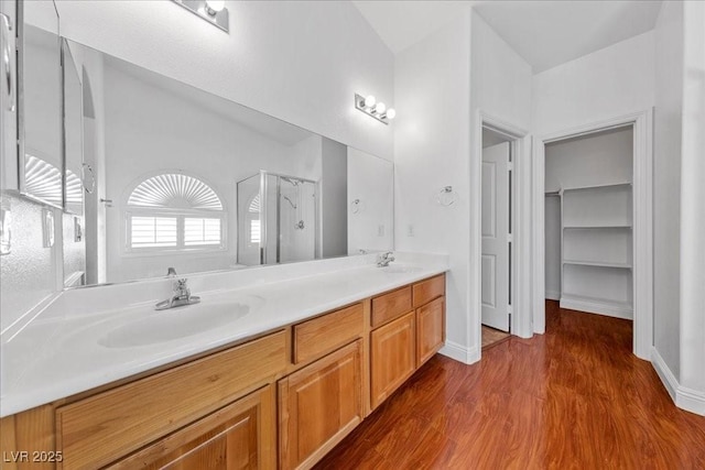 4029 Ricebird Way N, Las Vegas, NV 89084 - bathroom with a shower stall, double vanity, wood finished floors, and a spacious closet