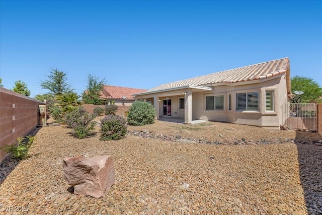 4029 Ricebird Way N, Las Vegas, NV 89084 - rear view of house with a tile roof, stucco siding, and a fenced backyard