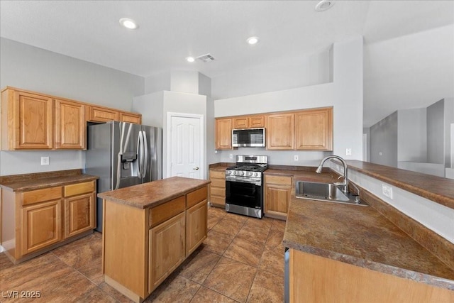 4029 Ricebird Way N, Las Vegas, NV 89084 - kitchen featuring stainless steel appliances, dark countertops, a center island, a peninsula, and recessed lighting