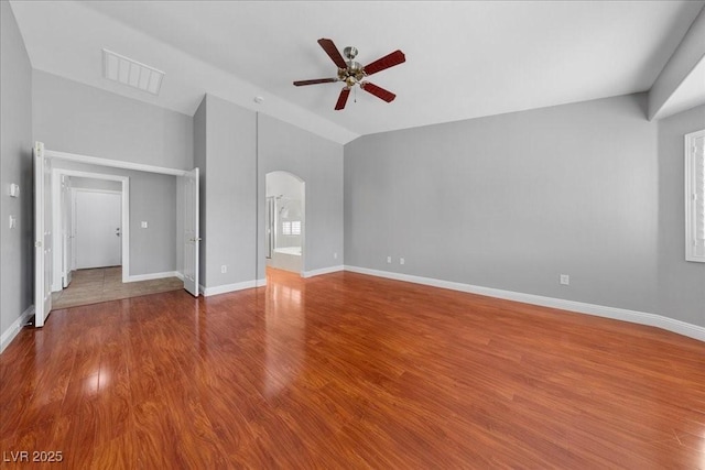 4029 Ricebird Way N, Las Vegas, NV 89084 - unfurnished room with arched walkways, ceiling fan, lofted ceiling, and wood finished floors