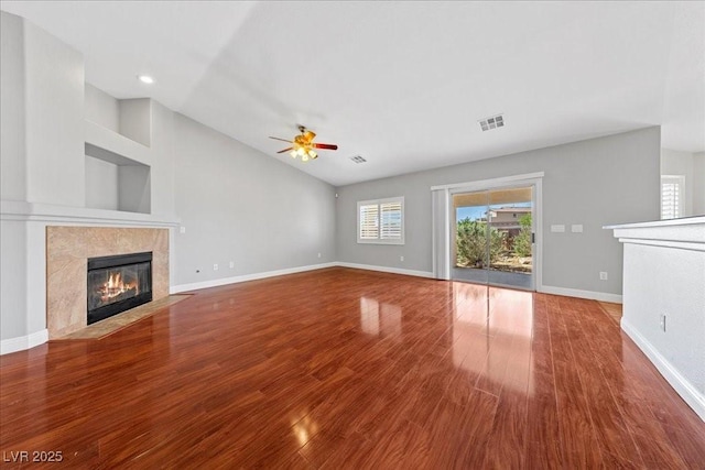 4029 Ricebird Way N, Las Vegas, NV 89084 - unfurnished living room featuring a high end fireplace, ceiling fan, wood finished floors, vaulted ceiling, and recessed lighting