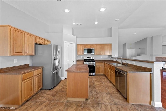 4029 Ricebird Way N, Las Vegas, NV 89084 - kitchen with stainless steel appliances, a peninsula, dark countertops, a kitchen island, and recessed lighting