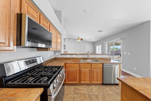 4029 Ricebird Way N, Las Vegas, NV 89084 - kitchen featuring stainless steel appliances, a ceiling fan, a peninsula, and vaulted ceiling