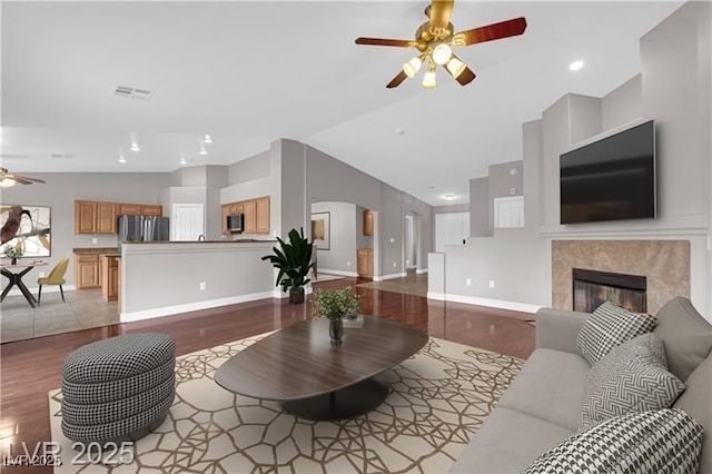 4029 Ricebird Way N, Las Vegas, NV 89084 - living room with a ceiling fan, wood finished floors, lofted ceiling, a fireplace, and recessed lighting